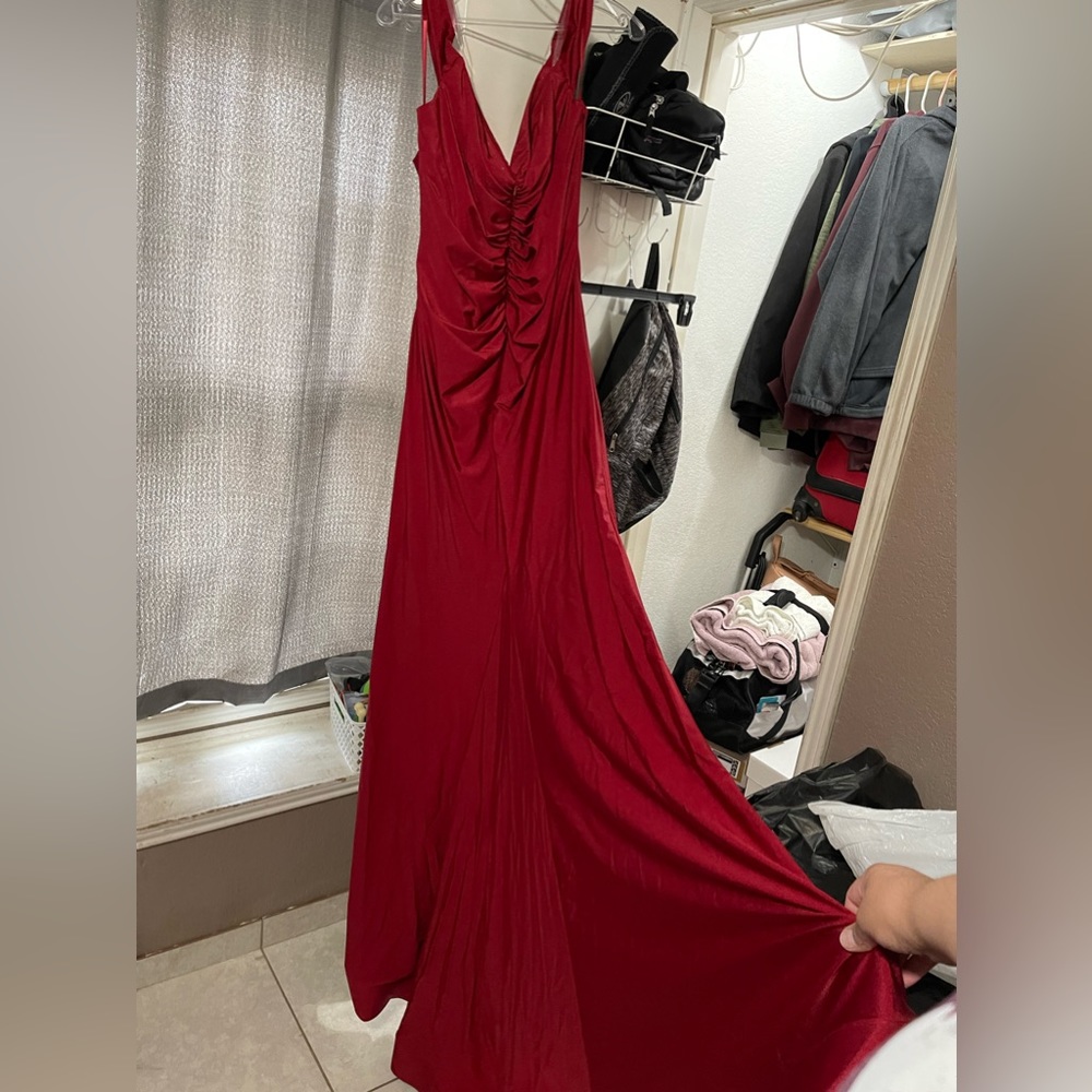 Burgundy shimmery mermaid dress with train and thigh slit.